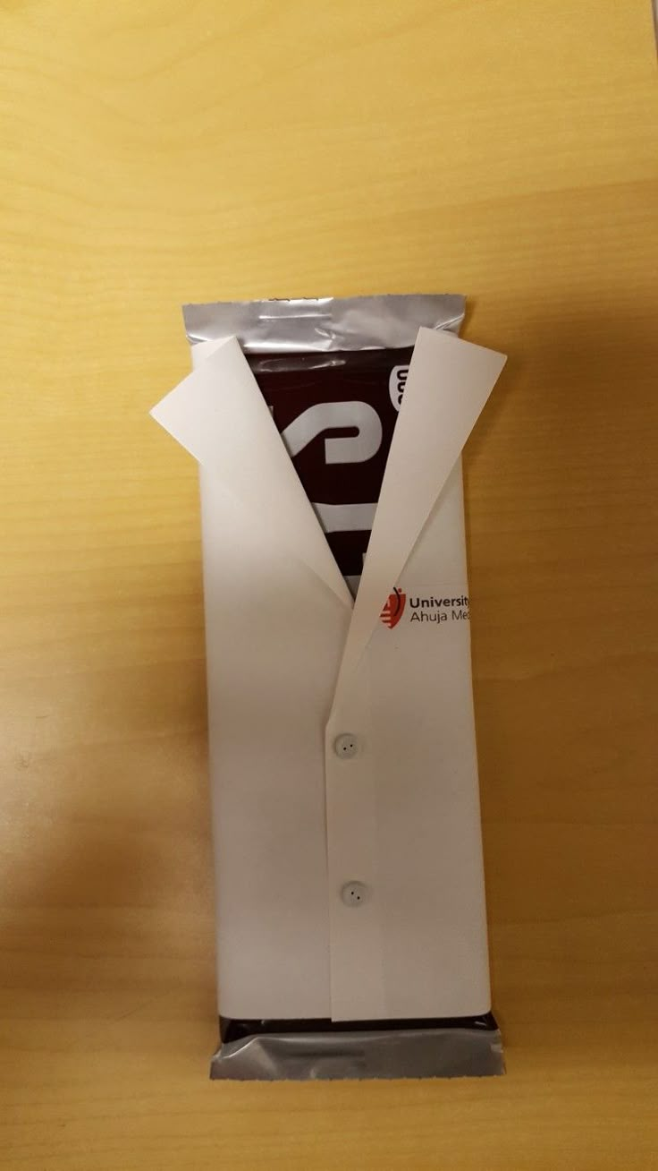 an open white shirt packaging on top of a wooden table