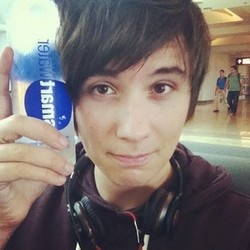 a young man holding up a can of pepsi