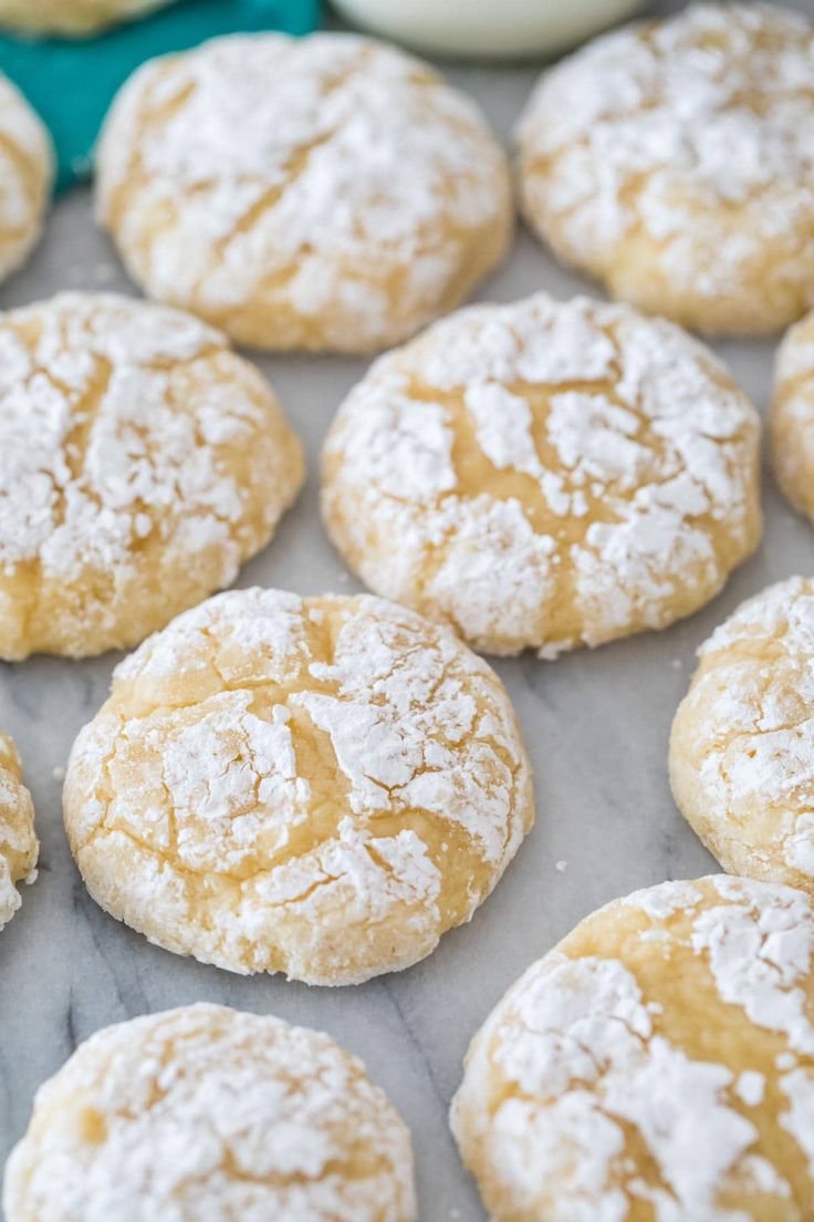 powdered sugar cookies on a baking sheet