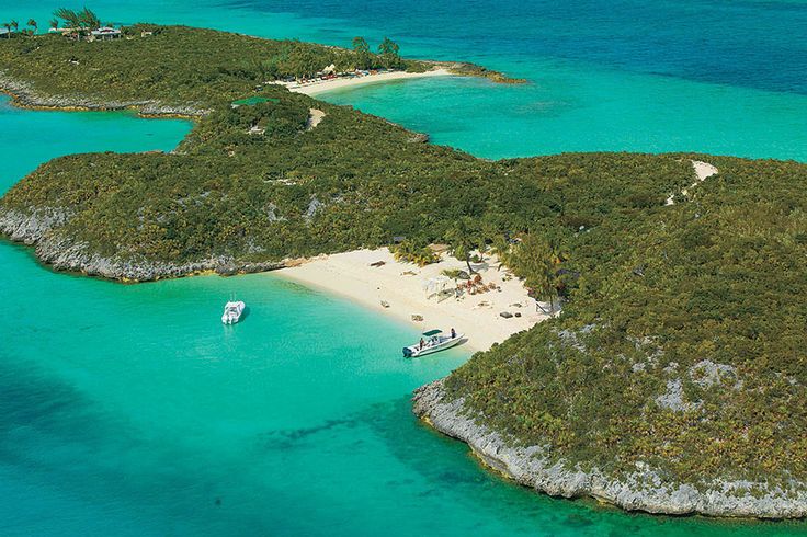 an island with several small boats in the water