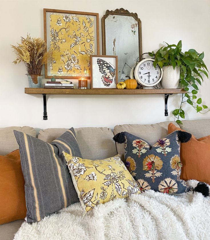 a living room filled with lots of pillows and decor