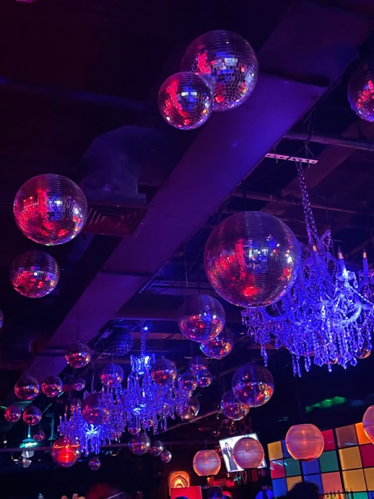 many disco balls are hanging from the ceiling