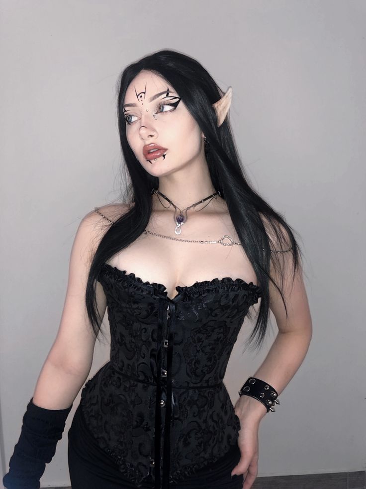 a woman with long black hair and horns on her head wearing a corset