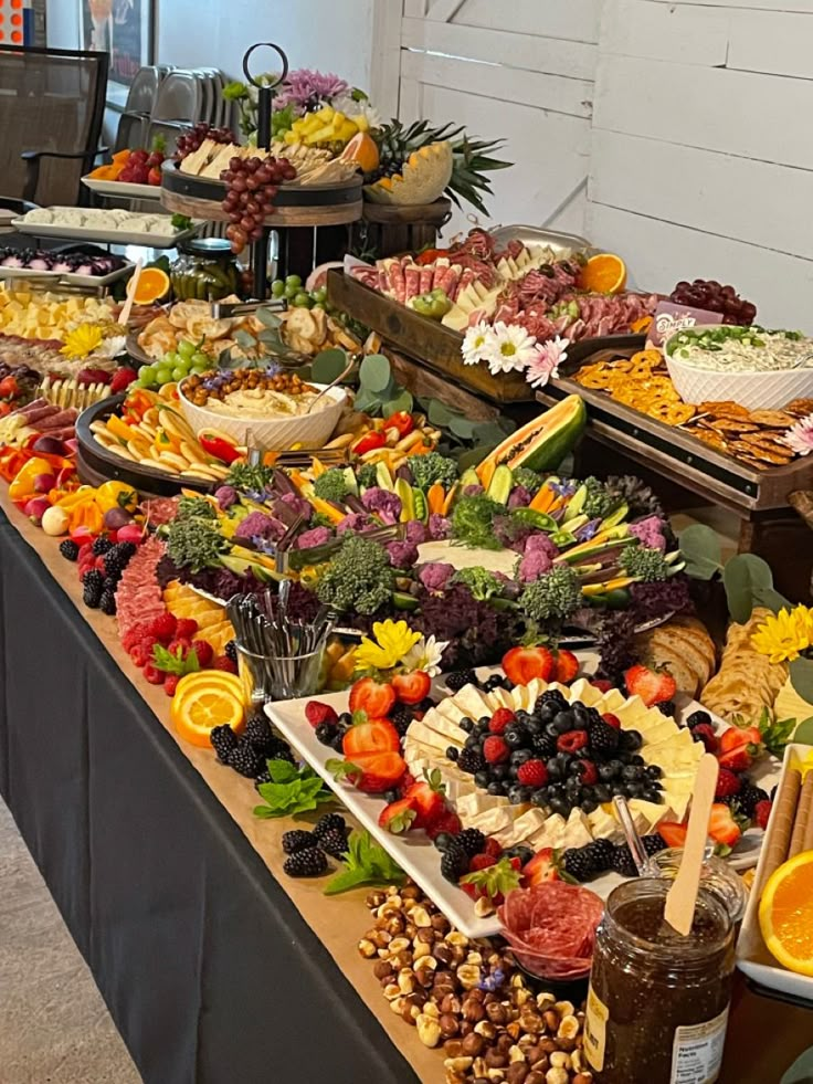 a buffet table filled with lots of different types of food and fruit on it's sides