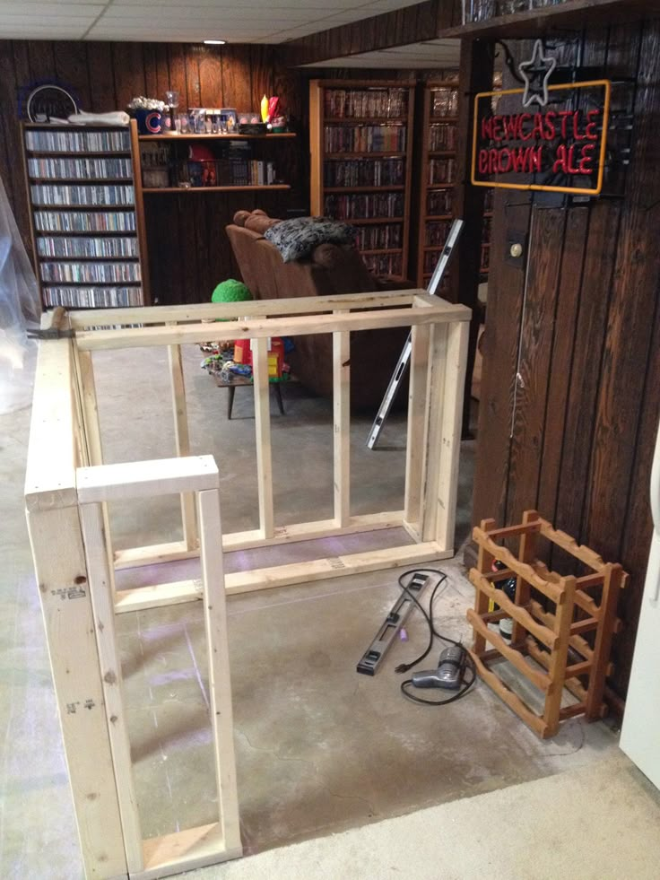 an unfinished room with bookshelves and shelves