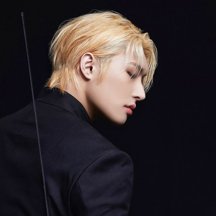 a man with blonde hair holding a violin