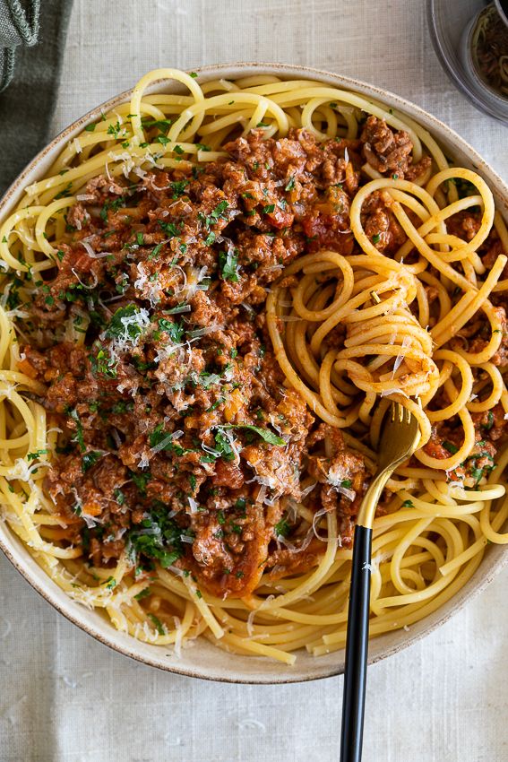 a bowl filled with spaghetti and meat sauce