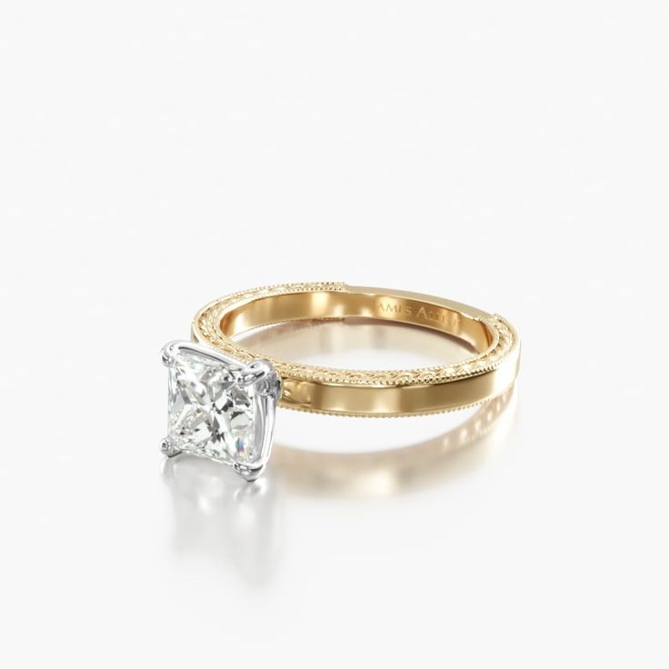 two gold rings with a diamond in the middle and one on top, against a white background