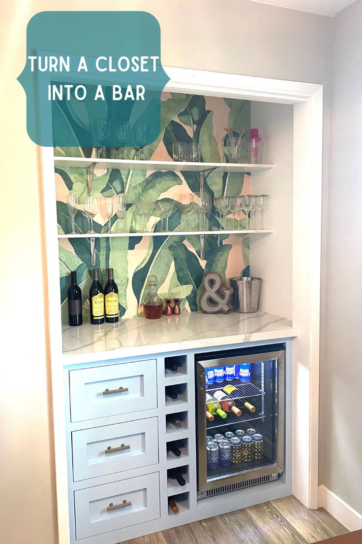 an open refrigerator in the corner of a room next to a wall with a plant painted on it