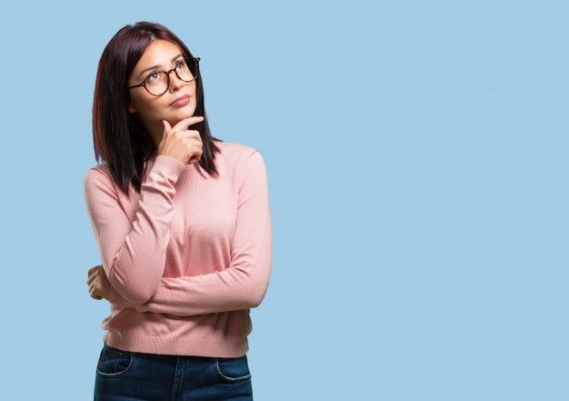 a woman wearing glasses is posing for the camera with her hand on her chin and looking up