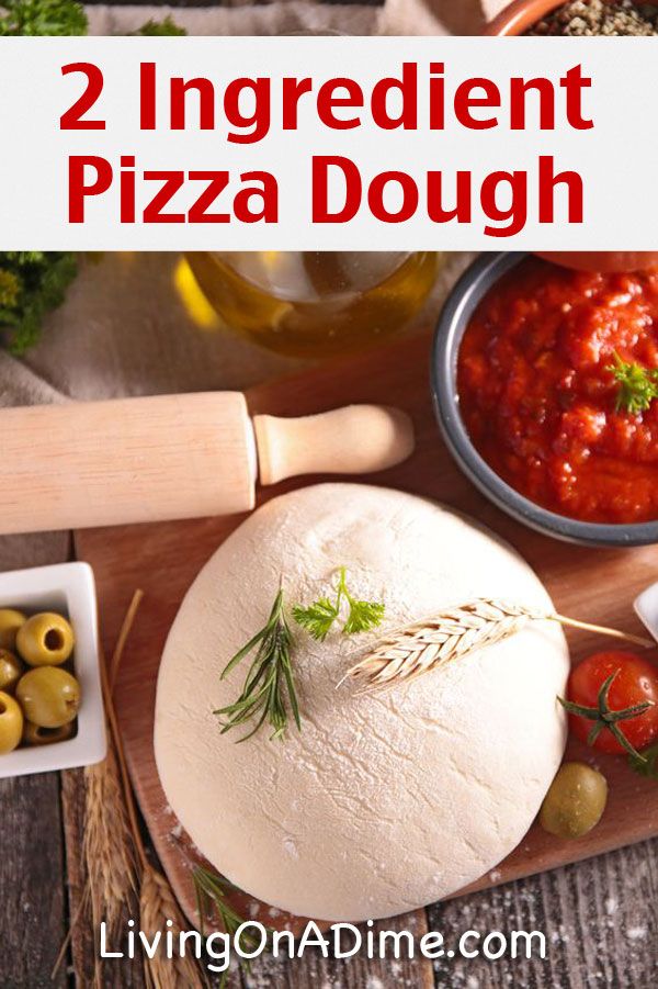 two ingredients for pizza dough on a cutting board with olives and breadsticks