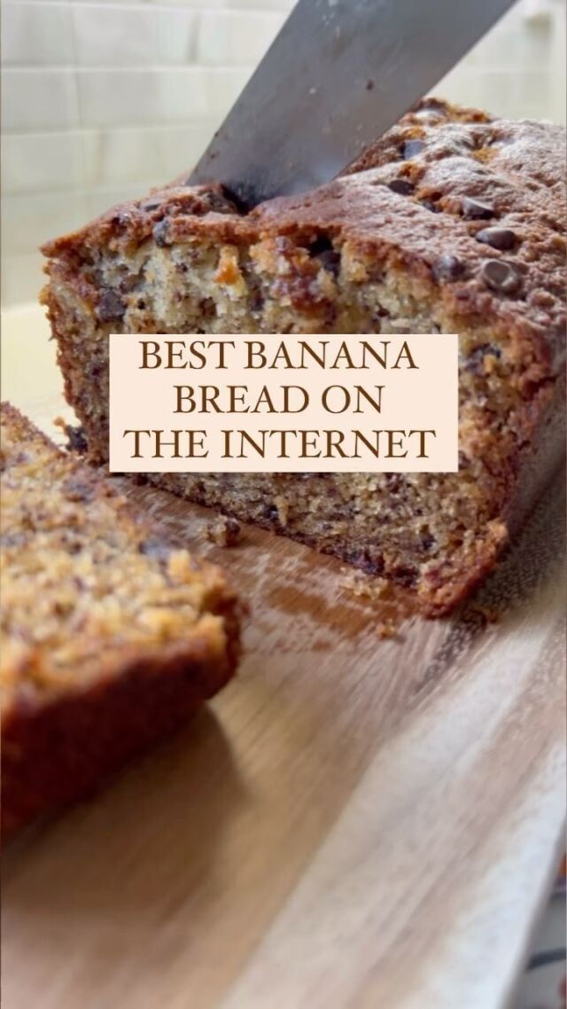 a loaf of banana bread sitting on top of a cutting board next to a knife