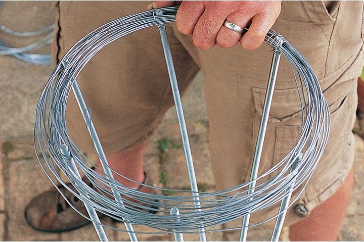 a man is holding a metal circular object