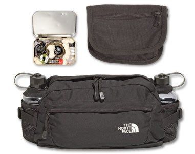 the north face fanny bag is shown with its contents laid out in front of it