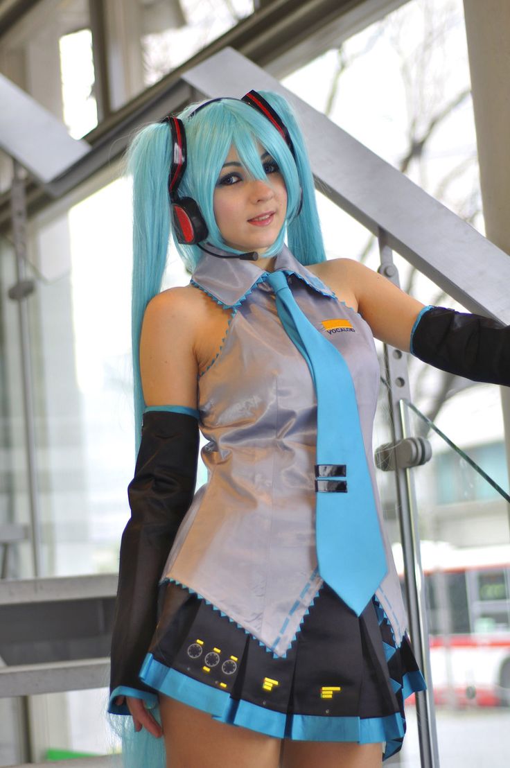 a woman with blue hair is dressed up like an anime character and posing for the camera