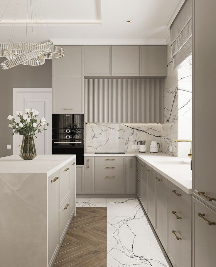 a kitchen with marble counter tops and white cabinets