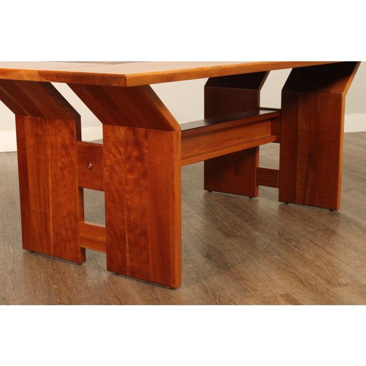 a wooden table sitting on top of a hard wood floor