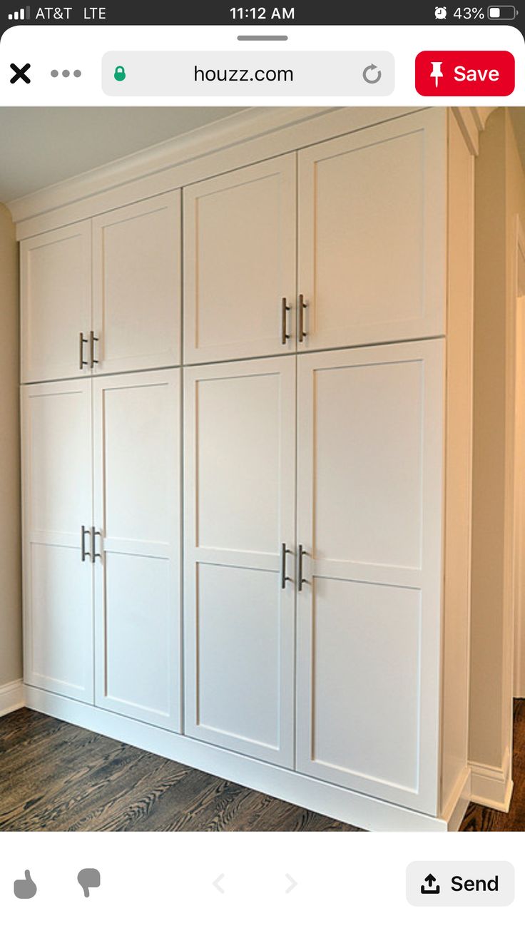 an image of a room with white cabinets on the wall and wood floors in it