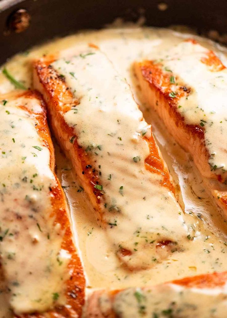 some meat covered in white sauce sitting in a pan