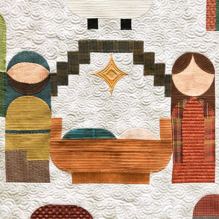 a quilted nativity scene with three people