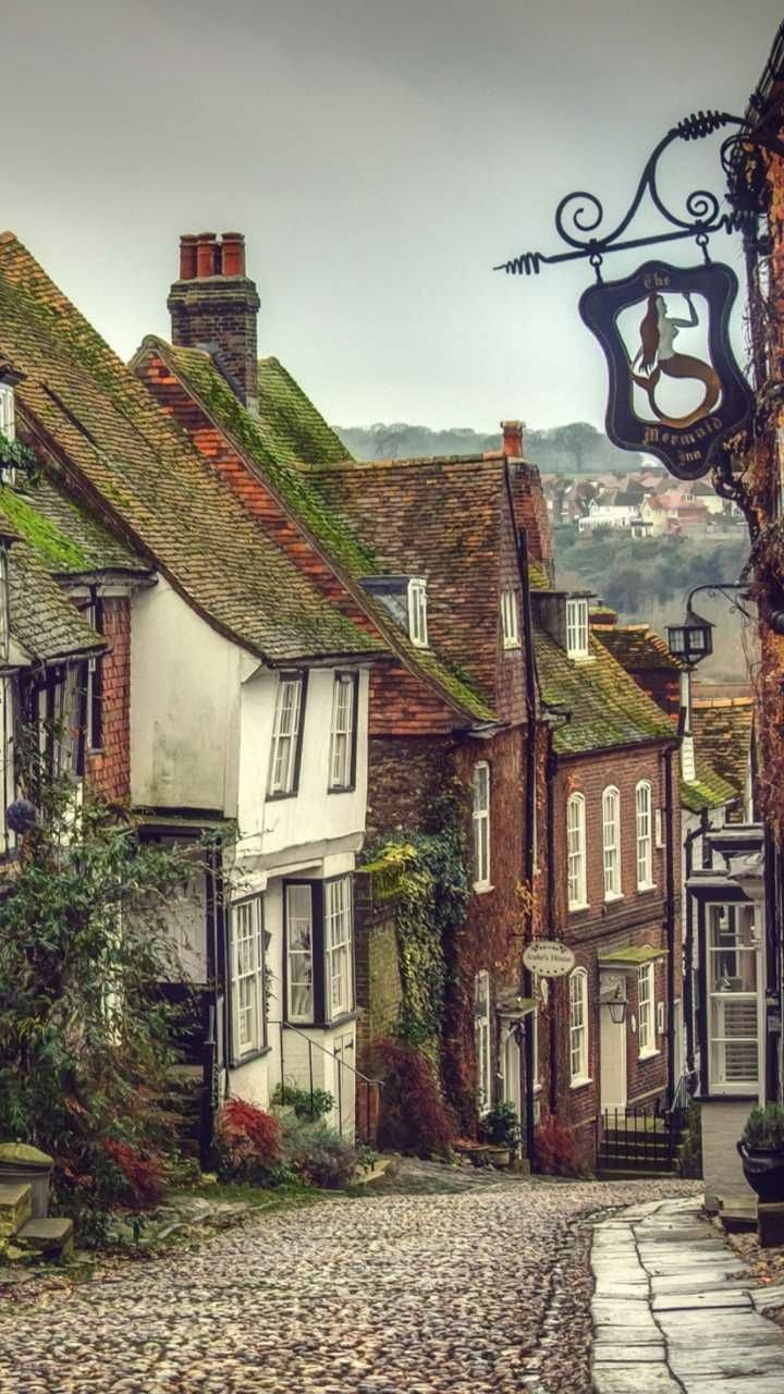 an old cobblestone street with houses on either side