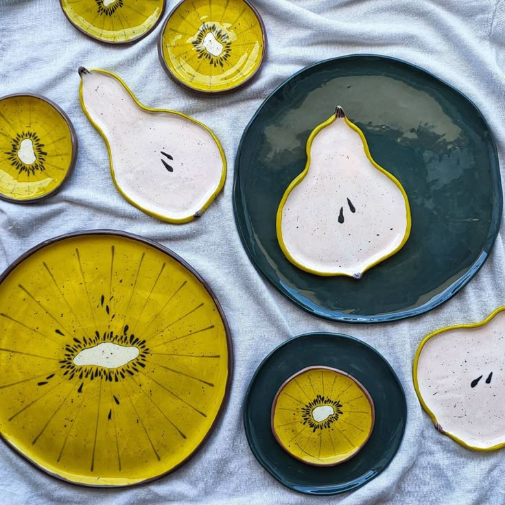 yellow and black plates with pears on them