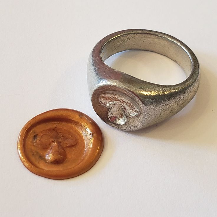 This signet ring is cast in lead-free pewter. The ring size when cast is 6.75. The sealing image is a bolete mushroom.       This is part of a series of signet rings I am making cast from lead-free pewter. Each master ring is hand sculpted to give a unique, rustic style, multi-dimensional relief image when used as a stamp to seal, with sealing wax. Wax Stamp Ring, Bolete Mushroom, Wax Seal Ring, Pewter Ring, Signet Rings Women, Food Fruit, Signet Rings, Multi Dimensional, Sealing Wax