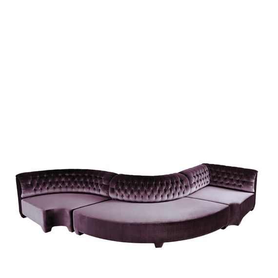 the curved couch is made from purple velvet