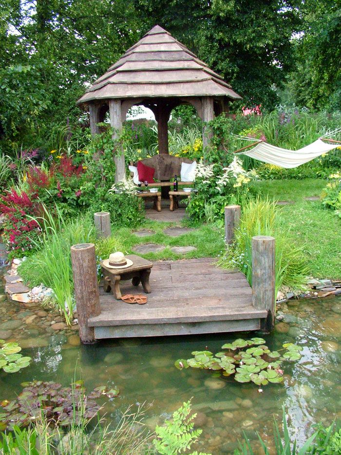 a wooden dock sitting in the middle of a garden