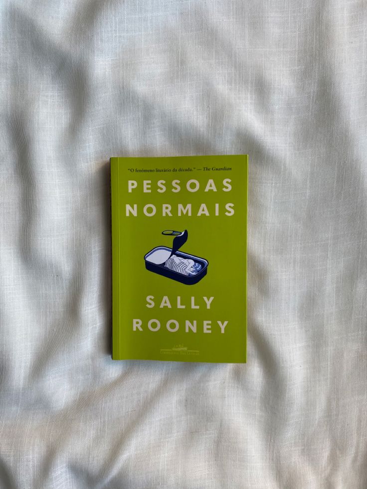 a book sitting on top of a bed next to a white comforter with the title pessoas normalis