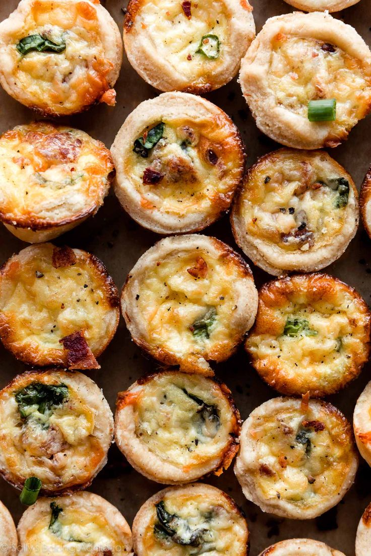 several small muffins with cheese and spinach on top