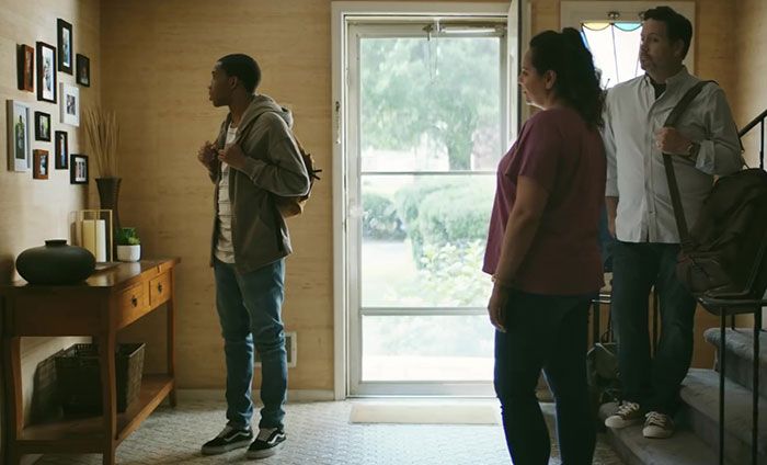 three people standing in front of a door