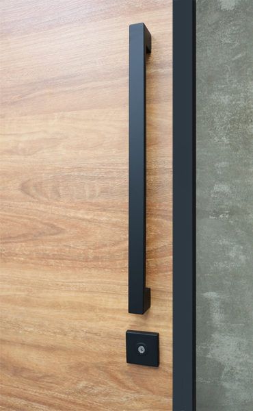 a door handle on a wooden door with black metal handles and wood grained doors