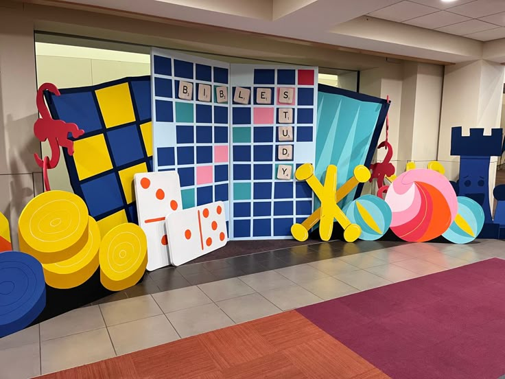 an indoor play area for children with colorful walls and rugs on the floor in front of them