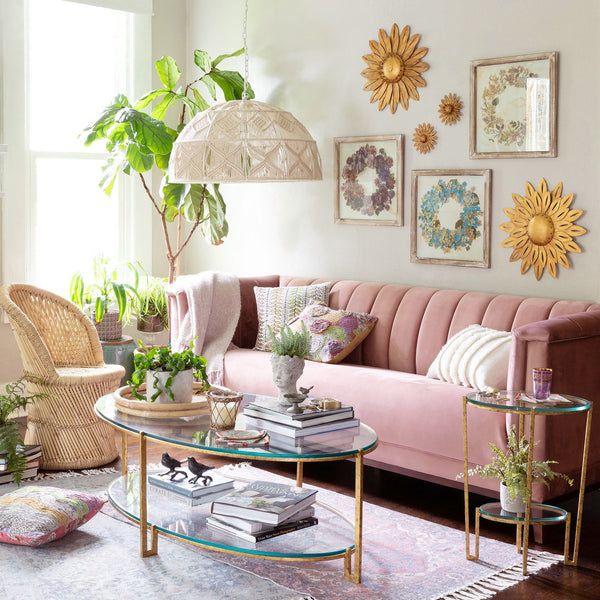 a living room filled with lots of furniture and plants on top of it's tables