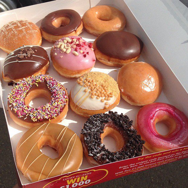 a box filled with lots of different flavored donuts