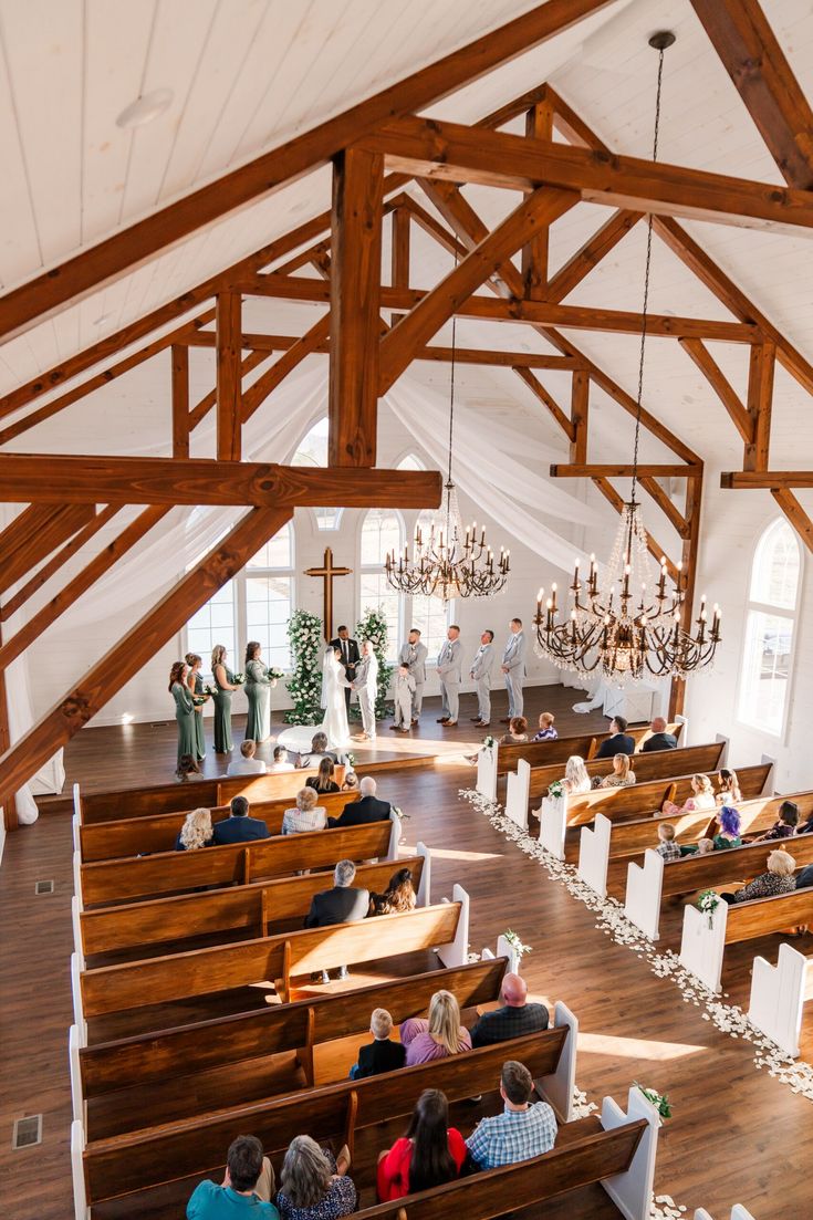 people are sitting in pews at the alter