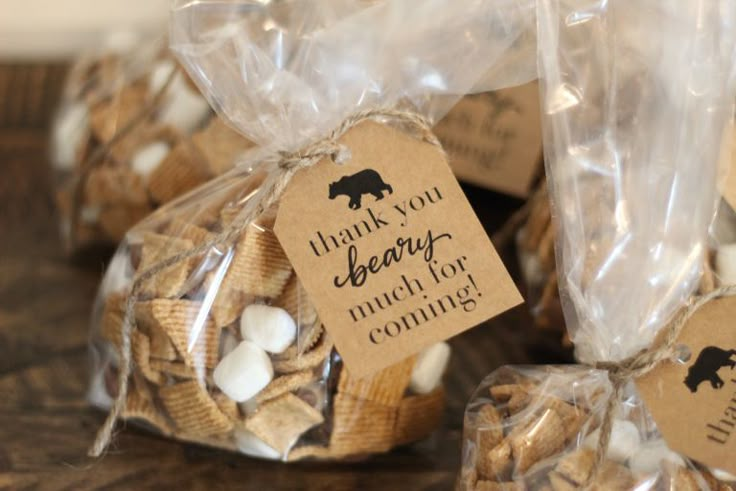 small bags filled with marshmallows on top of a wooden table