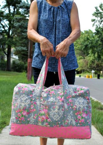 an older woman is holding a large floral bag