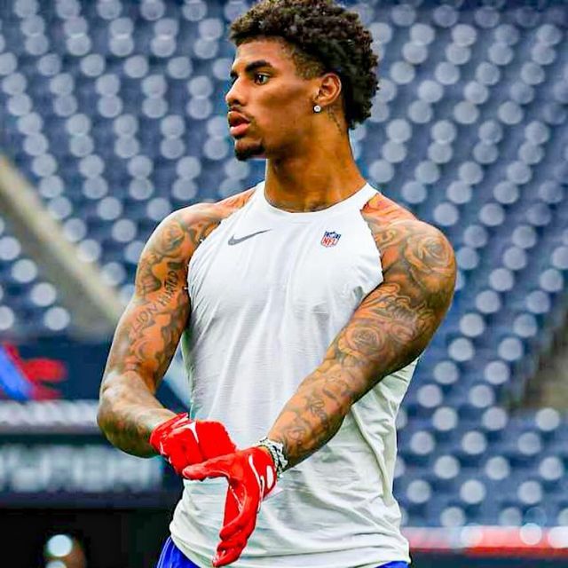 a close up of a person with a glove in his hand on a football field