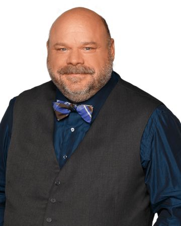 a bald man wearing a vest and bow tie