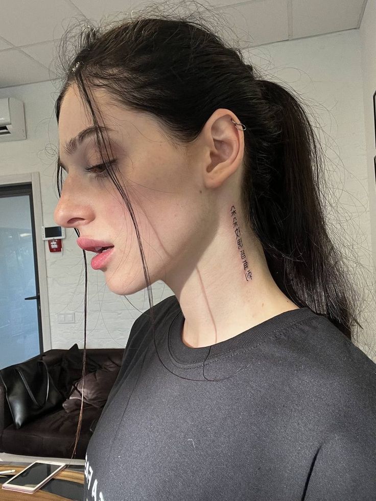 a woman with a tattoo on her neck