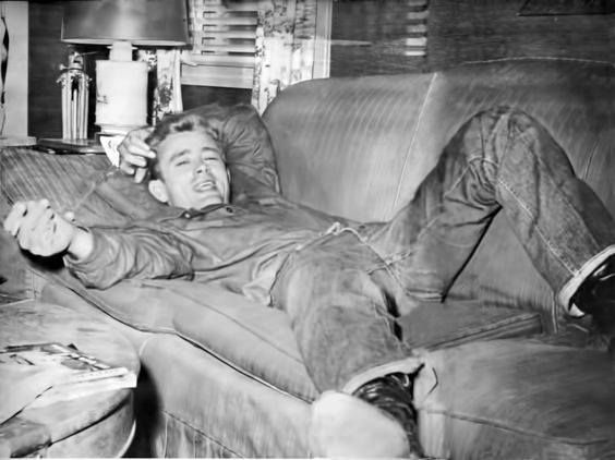 a man laying on top of a couch in a living room