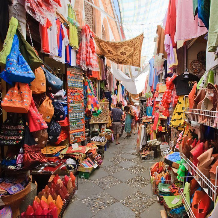 an outdoor market with many colorful items for sale