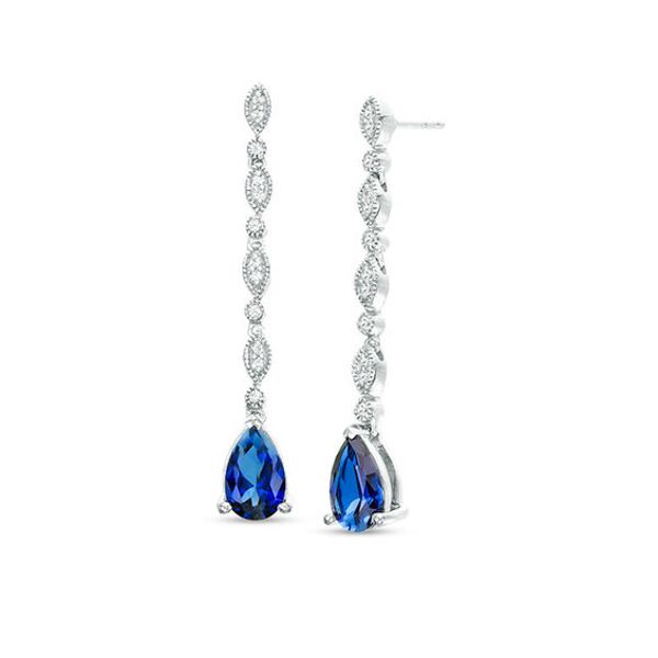 Bursting with colour, these fabulous vintage-inspired drop earrings are anything but ordinary. Fashioned in sterling silver, each enticing drop features an 8.0 x 5.0mm pear-shaped lab-created bright blue sapphire dangle. Along the linear drop, lab-created white sapphires in milgrain-lined bezel settings alternate with paired created sapphires in marquise-shaped frames lined with intricate milgrain detailing. Polished to a bright shine, these post earrings secure comfortably with friction backs. Sapphire Earrings Drop, Sapphire Drop Earrings, Wedding Earrings Drop, Swirl Earrings, Coin Jewelry, Elizabeth Taylor, Sapphire Earrings, Sapphire Stone, White Sapphire