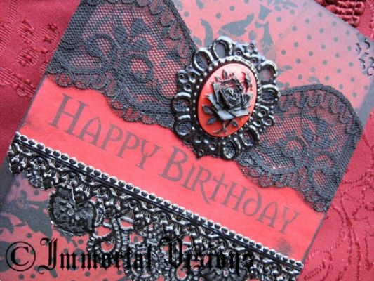 a red and black birthday card with lace