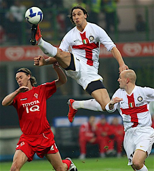 two men are playing soccer on the field