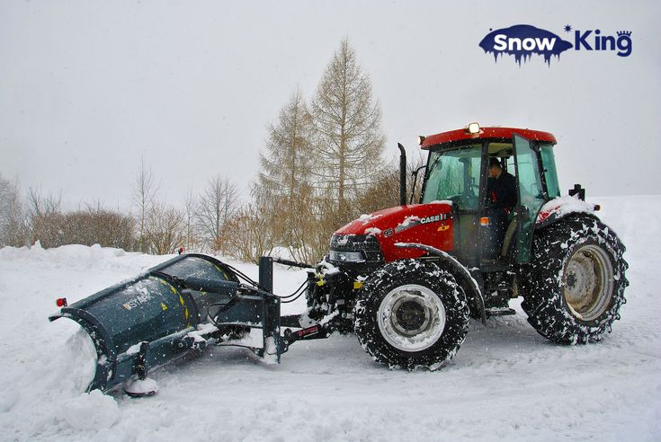 a tractor is plowing the snow with it's front end in position,