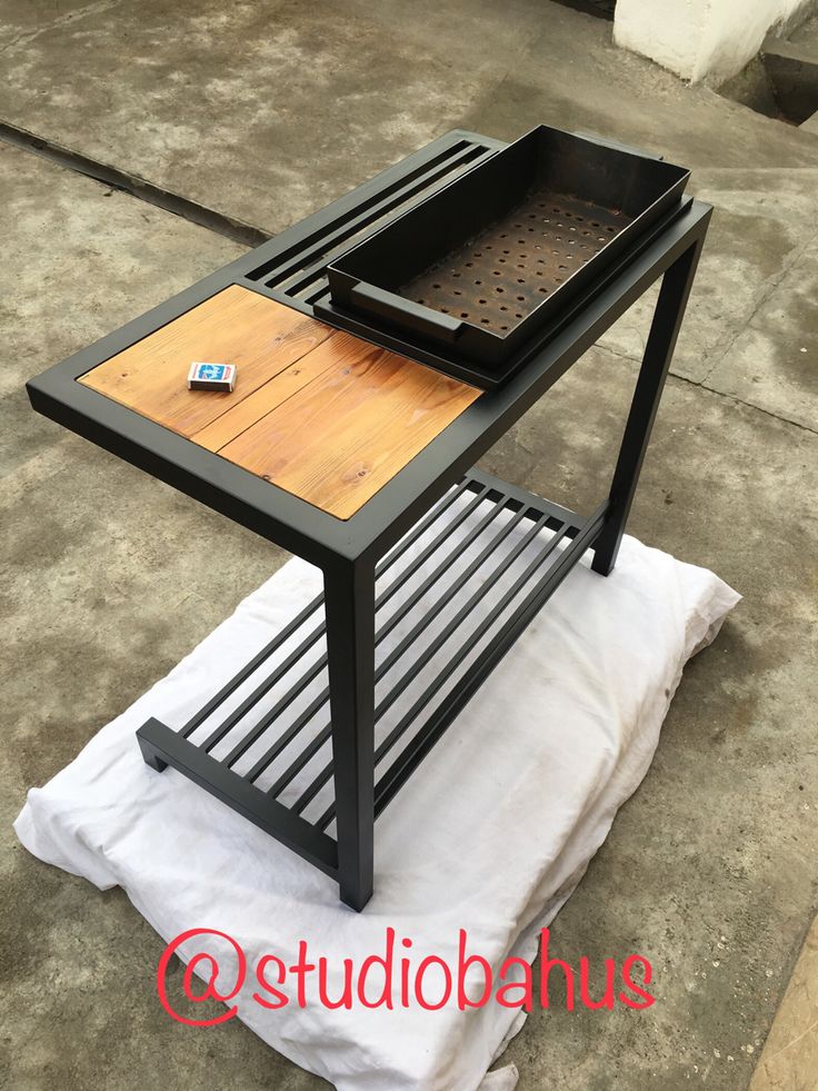 a table with a grill on it sitting on top of a piece of white paper