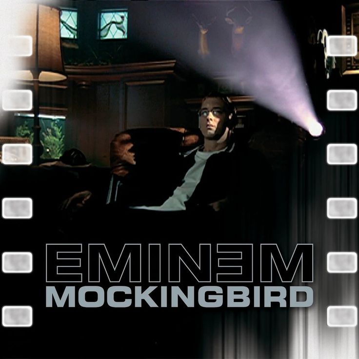 a man sitting on top of a couch in front of a tv screen with the words'emiinem mockingbird '